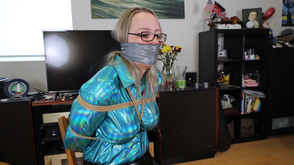 The bondage nightmare of Summer! Wearing a shiny aqua blue blouse, Summer gets tied by the burglar, tightly wraparound gagged and unable to move an inch!