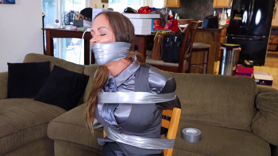 Cagney Tight is the sexy bank manager tightly wraparound tape gagged and taped up to a chair during a robbery!